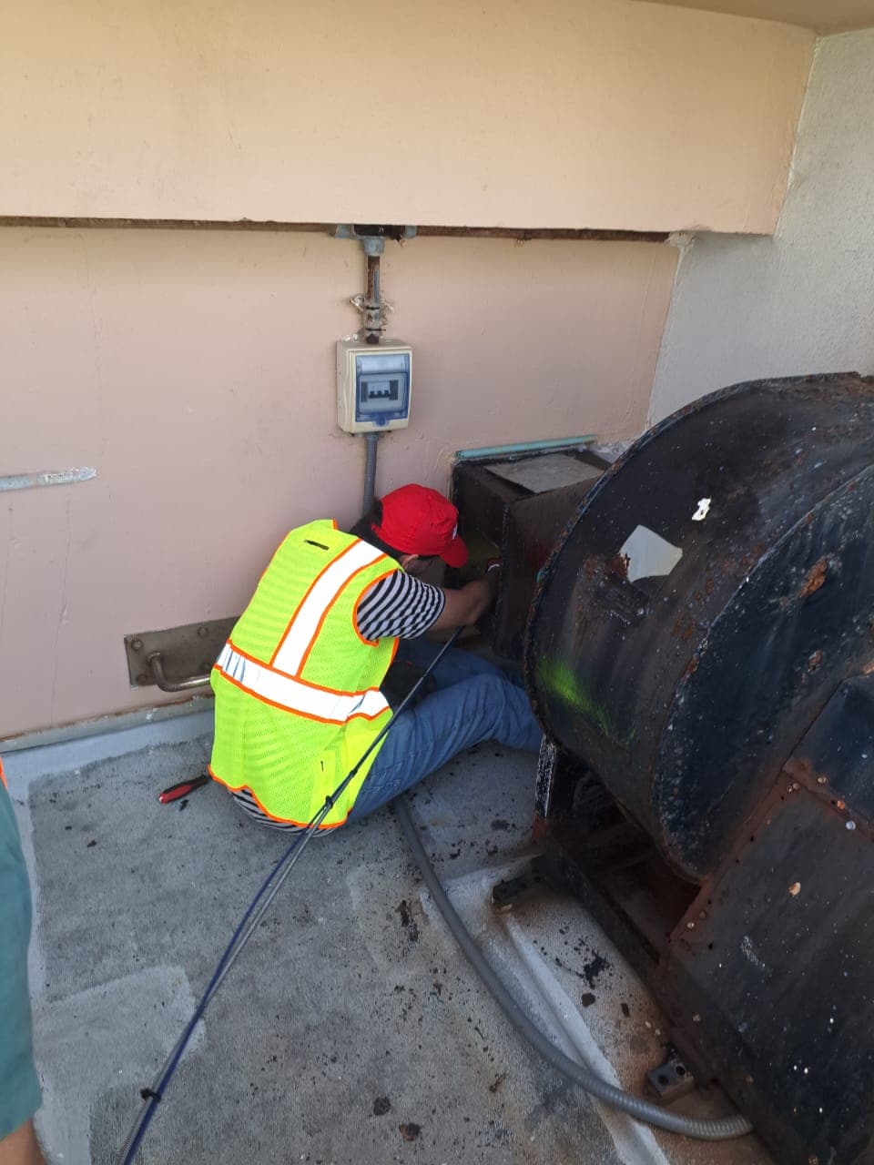 Servicing an industrial rooftop extractor.